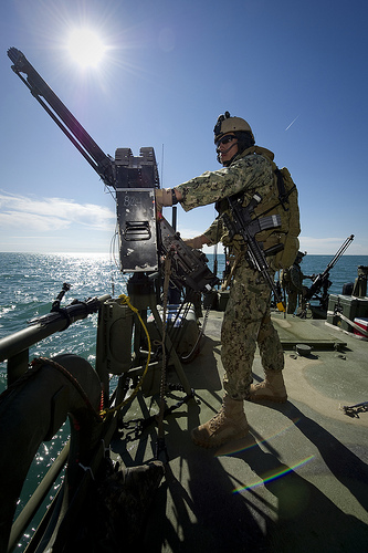 Electronics Technician 3rd Class Richard Zapada mans an M240 machine gun.